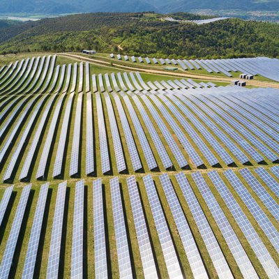 Aerial view of very large solar field in a green landscape