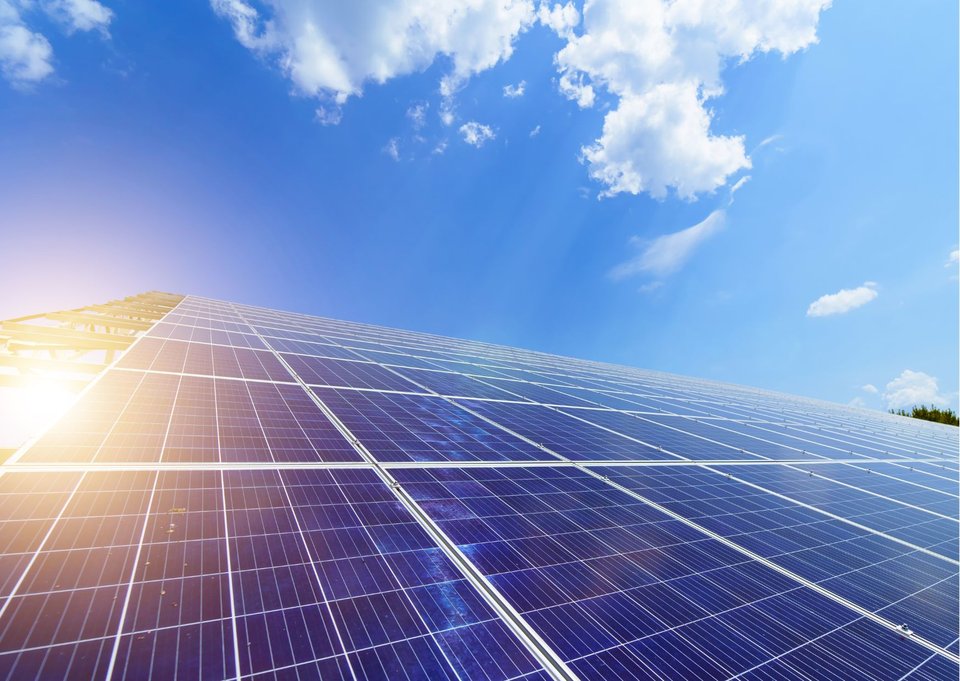 Abstract, view up long array of panels with sky, lens flare