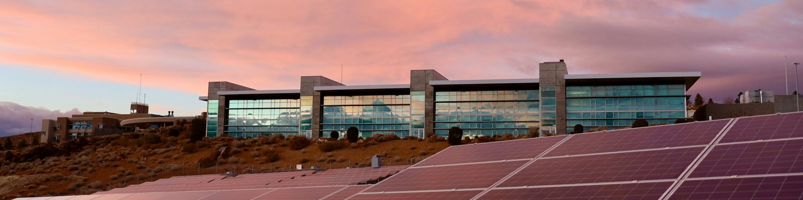 solar panels on brown field under white clouds during daytime