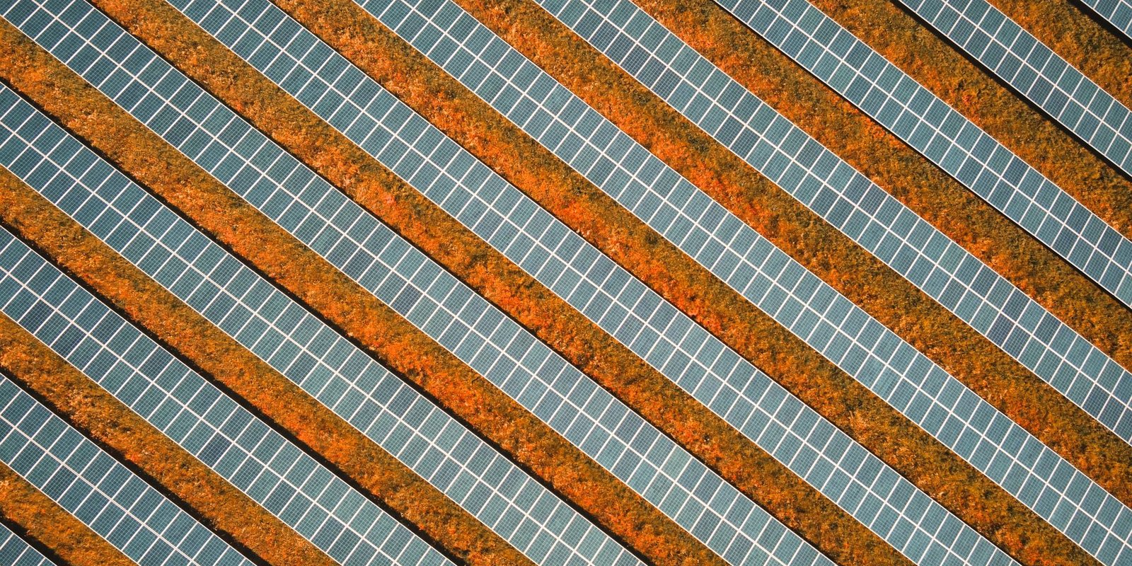 Aerial view of solar panels on red soil