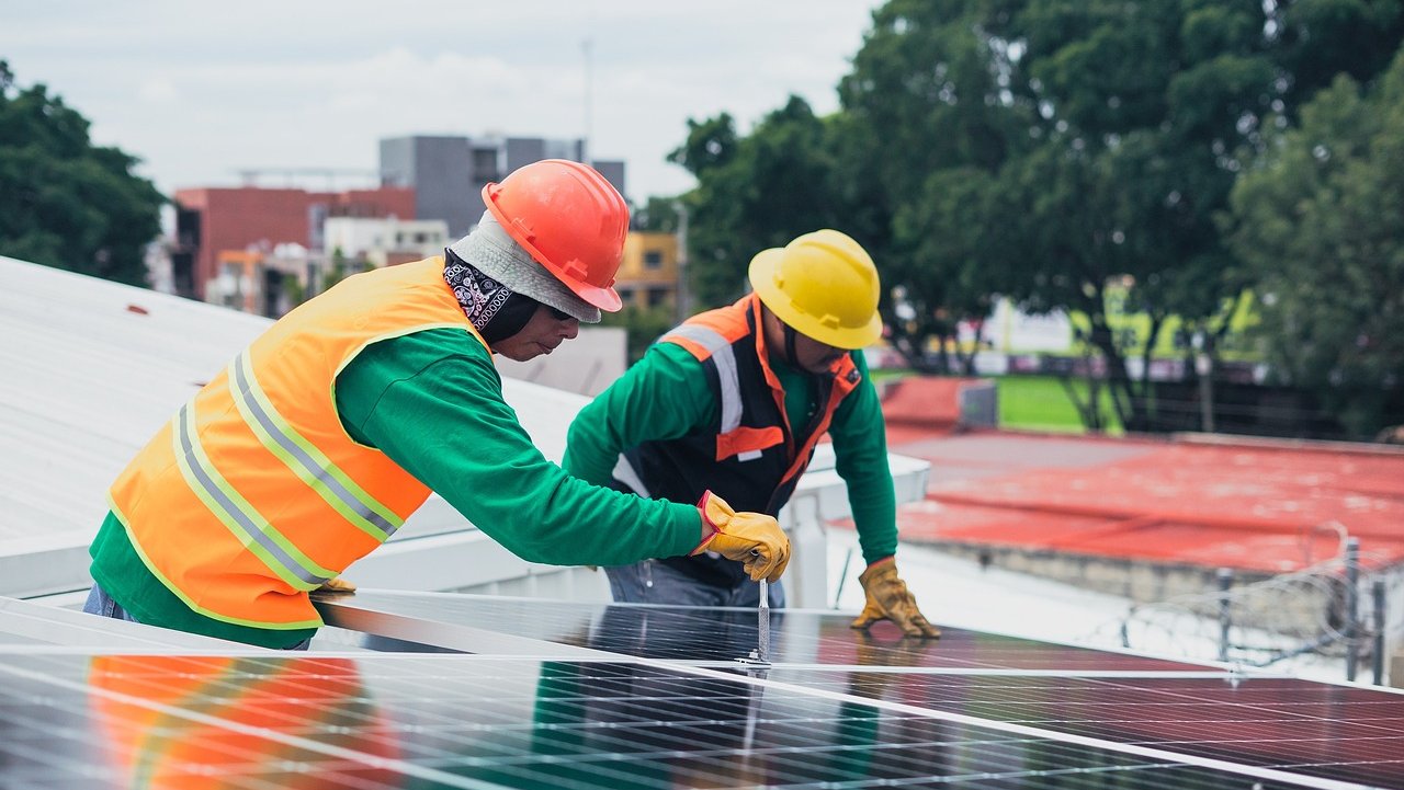 Workers installing solar panels
